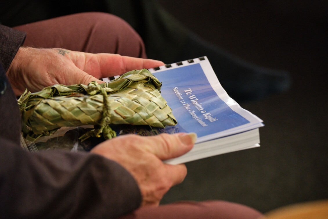 Hands holding the Kāpiti Whaitua Implementation Plan 